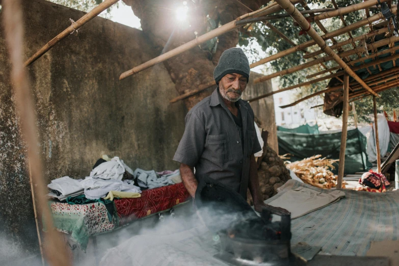 a man standing in front of some food on a stove