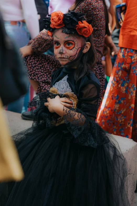 a child in costume for a day of the dead event