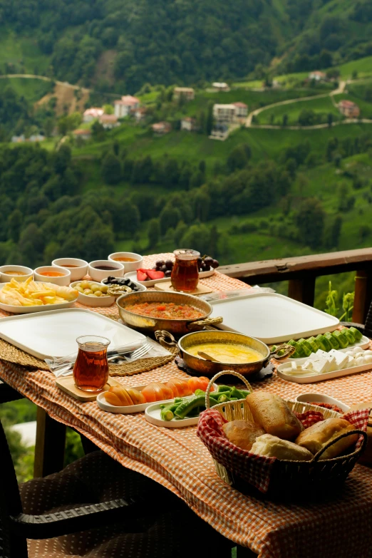 many plates of food are on an outdoor table