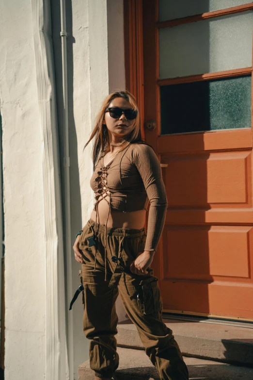 a woman with sunglasses on standing in front of a door