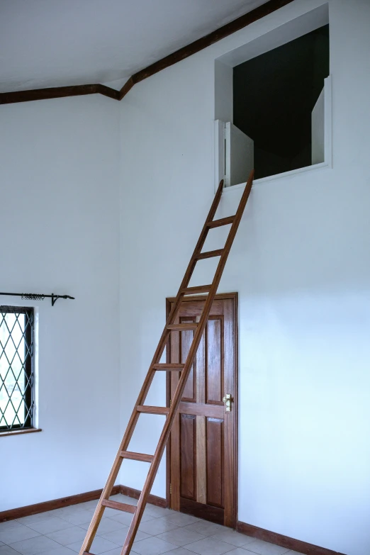 the ladder is leaning against the wall in the corner of this room