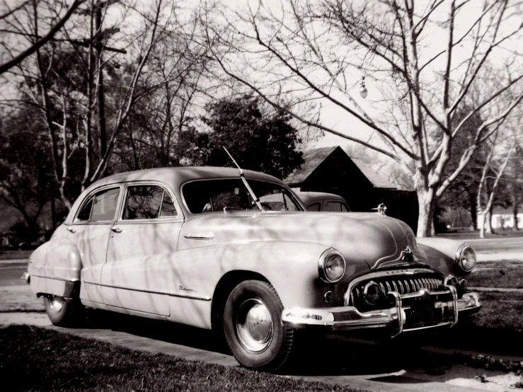 a car parked on a driveway near a house