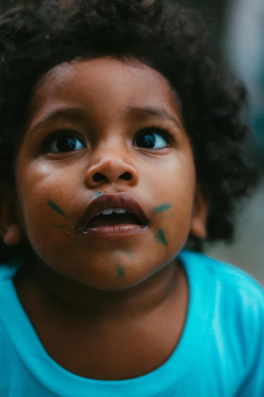 a young child with fake eyelashes on their face