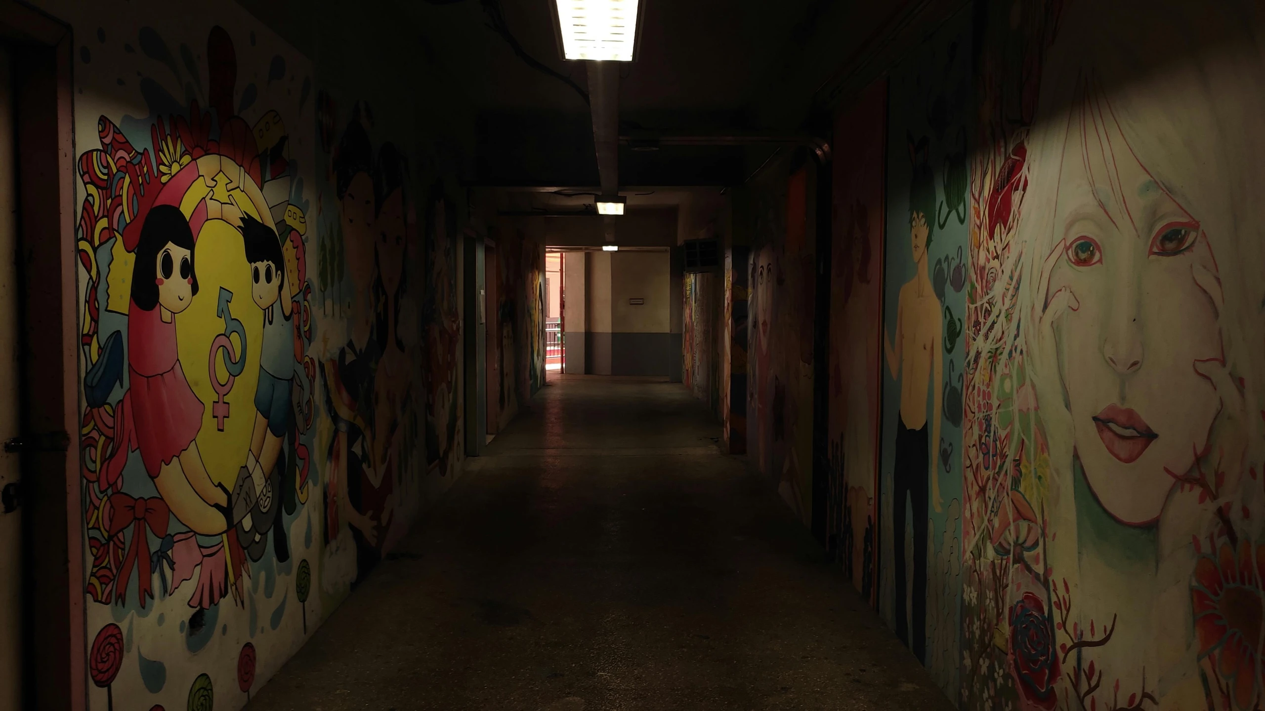 a long hallway with some wall art painted on the walls