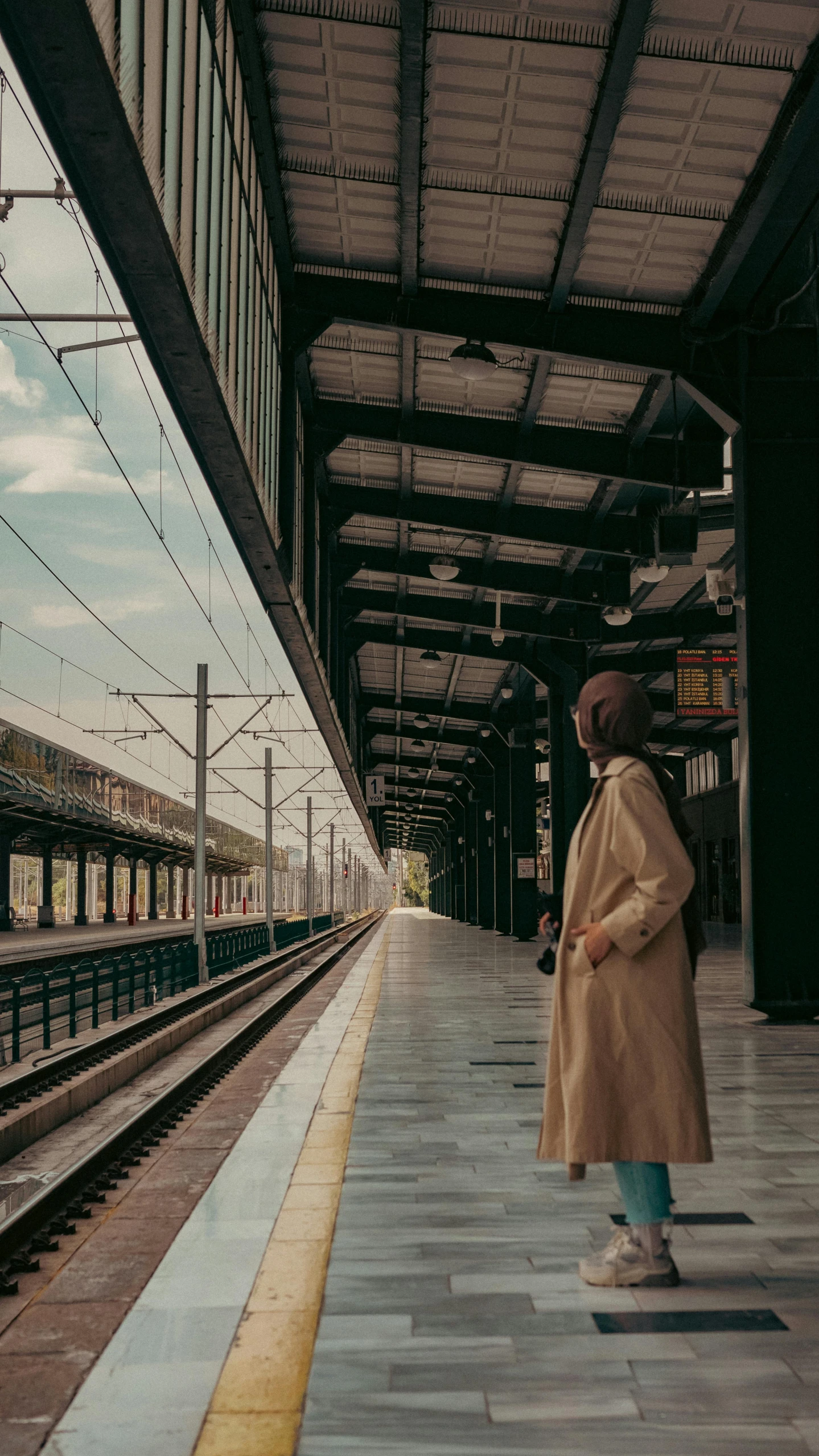 a person is waiting on a platform for the train