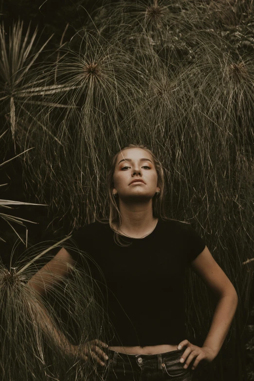 a woman that is standing next to a tree