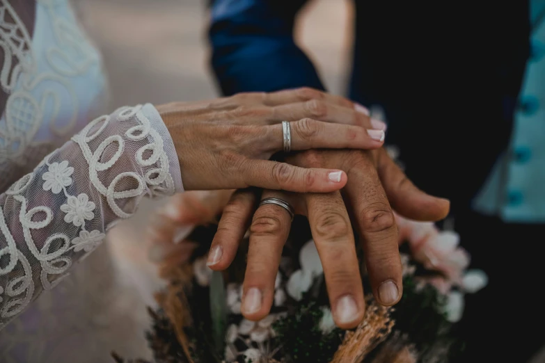 the people holding each other's hands as they hold them