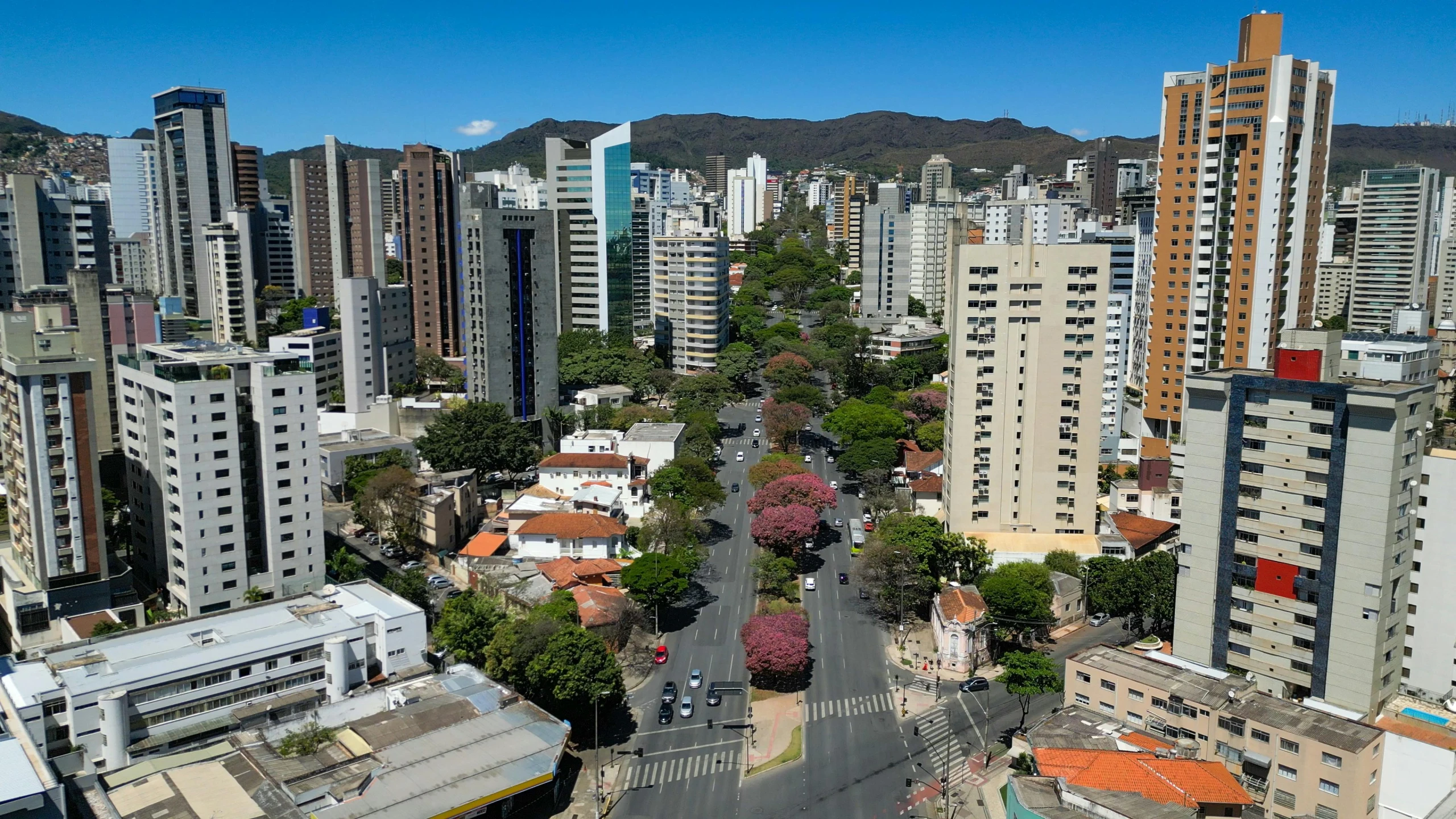 an aerial view of tall buildings with a city in the background