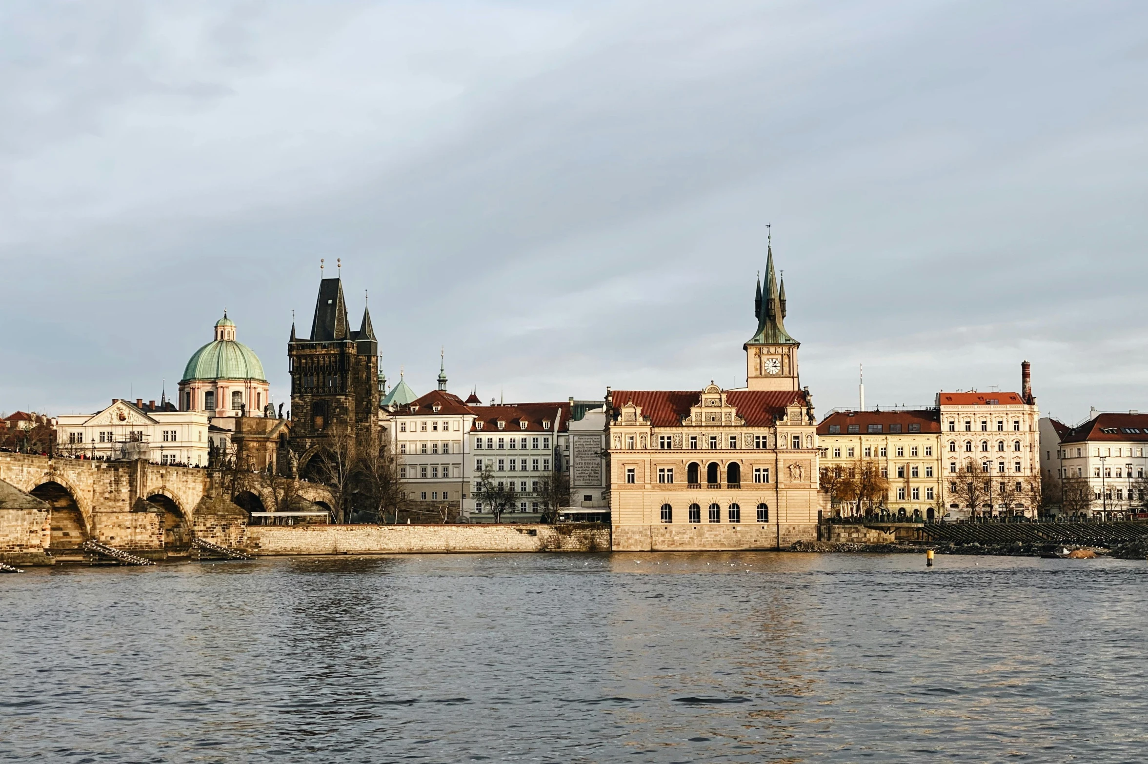 an old bridge is visible near some buildings and water