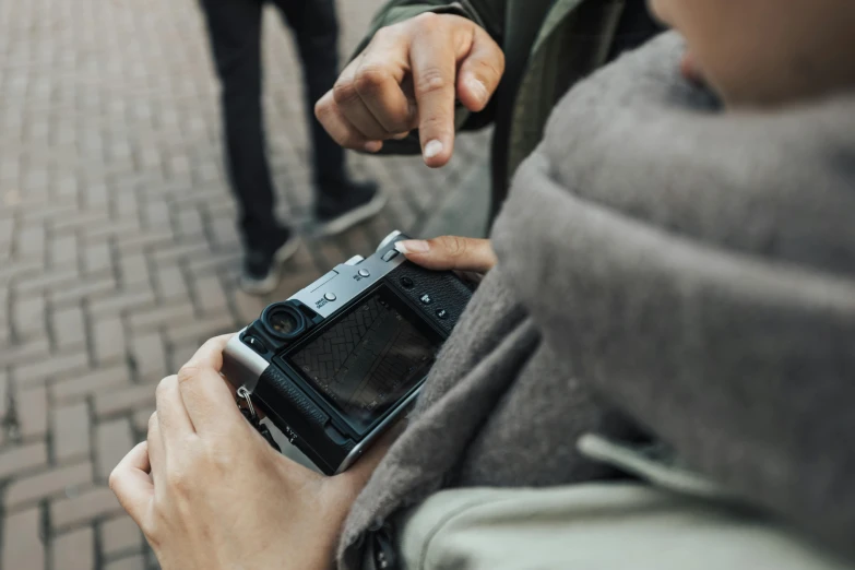 a person holding up a smart phone with their left hand