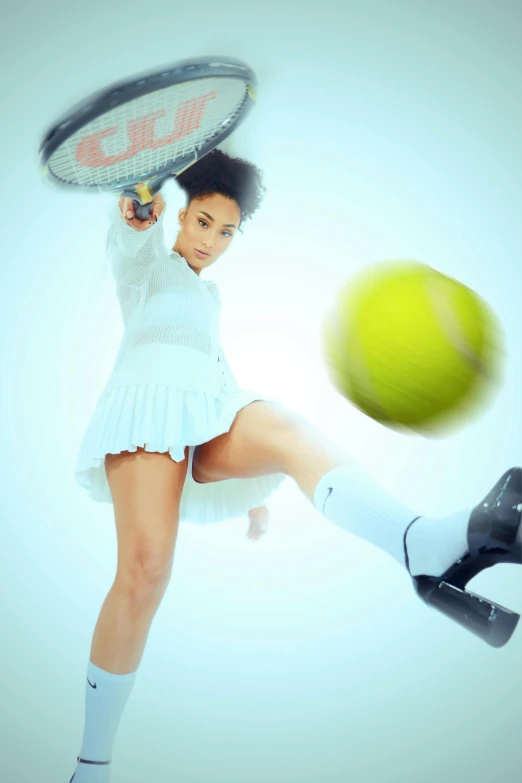 a girl is swinging at a tennis ball