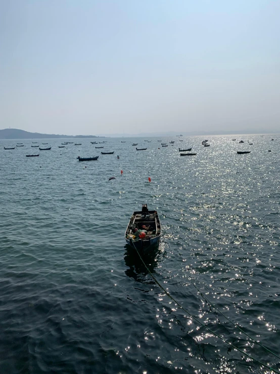 several small boats floating in the open water