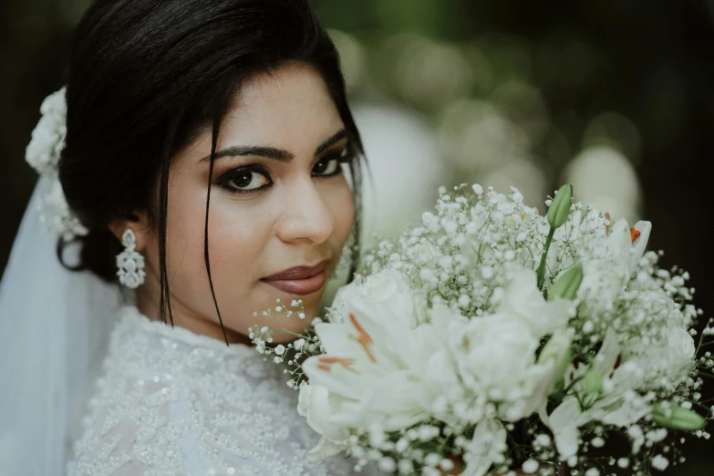 the bride is holding a bouquet of flowers