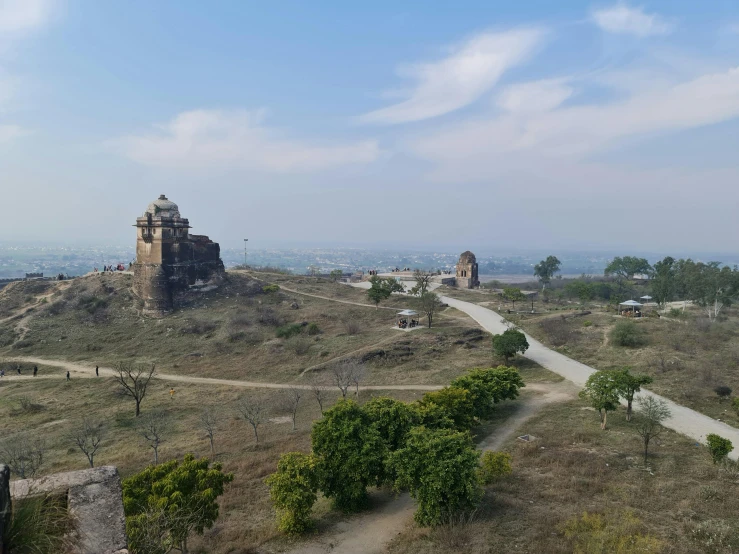 a road on a hill leading into a castle