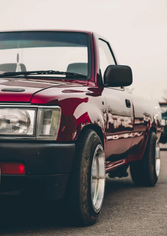 the front of an old red pick up truck