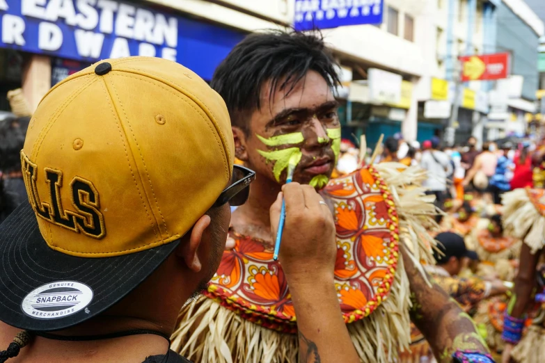 there are people with painted faces at the festival