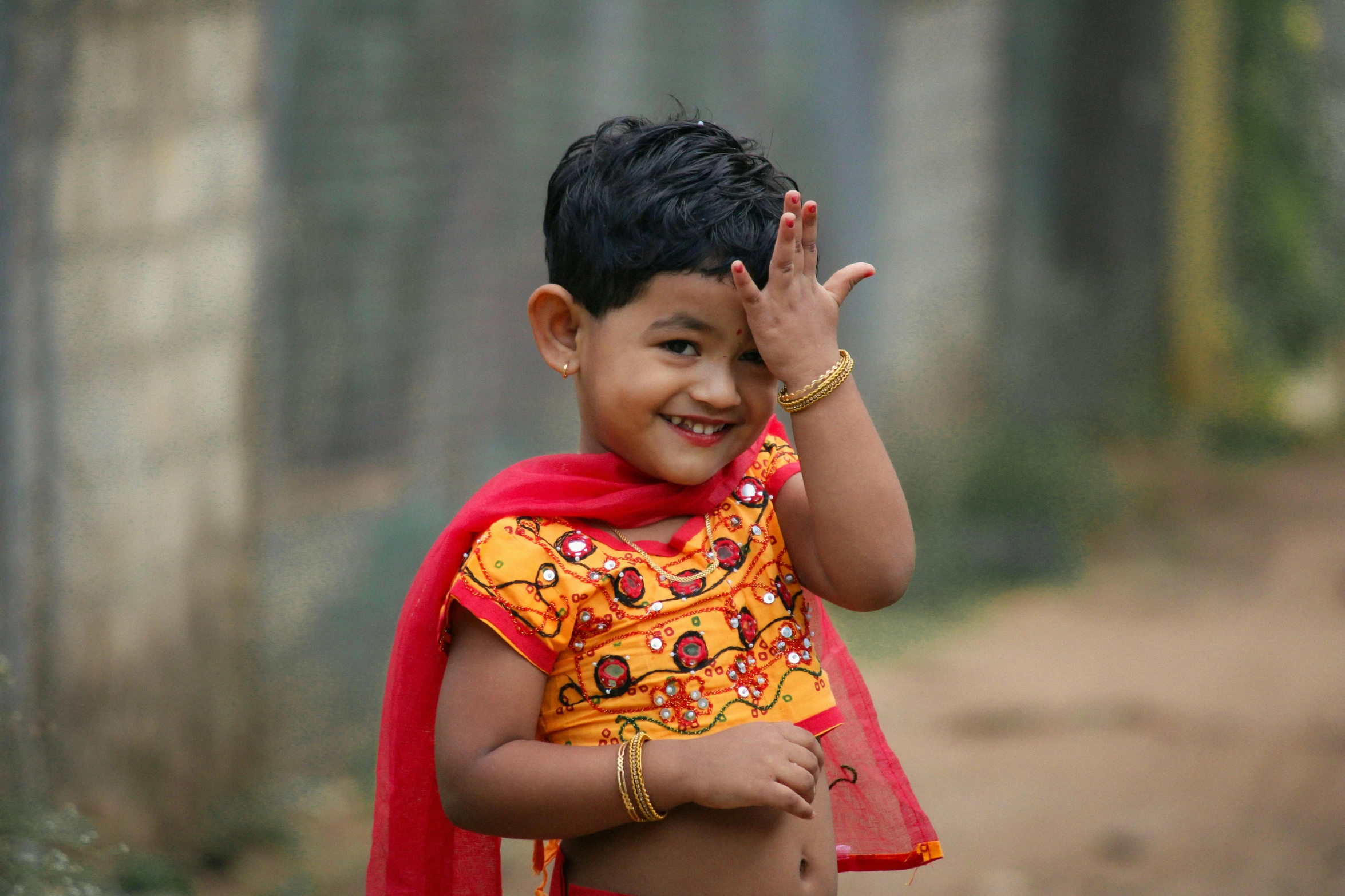 there is a  wearing a red sari and smiling