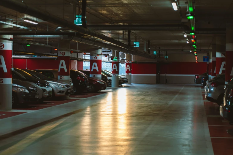 there are many cars parked in this parking garage