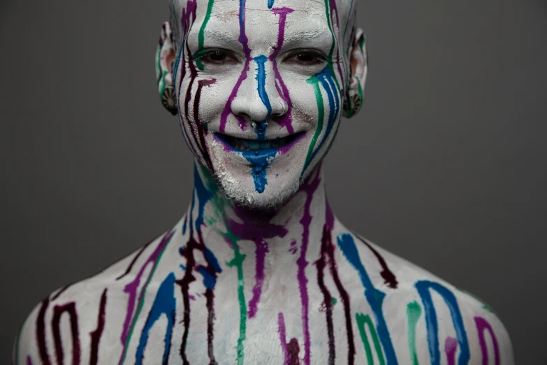 a man with artistic paint painted all over his face