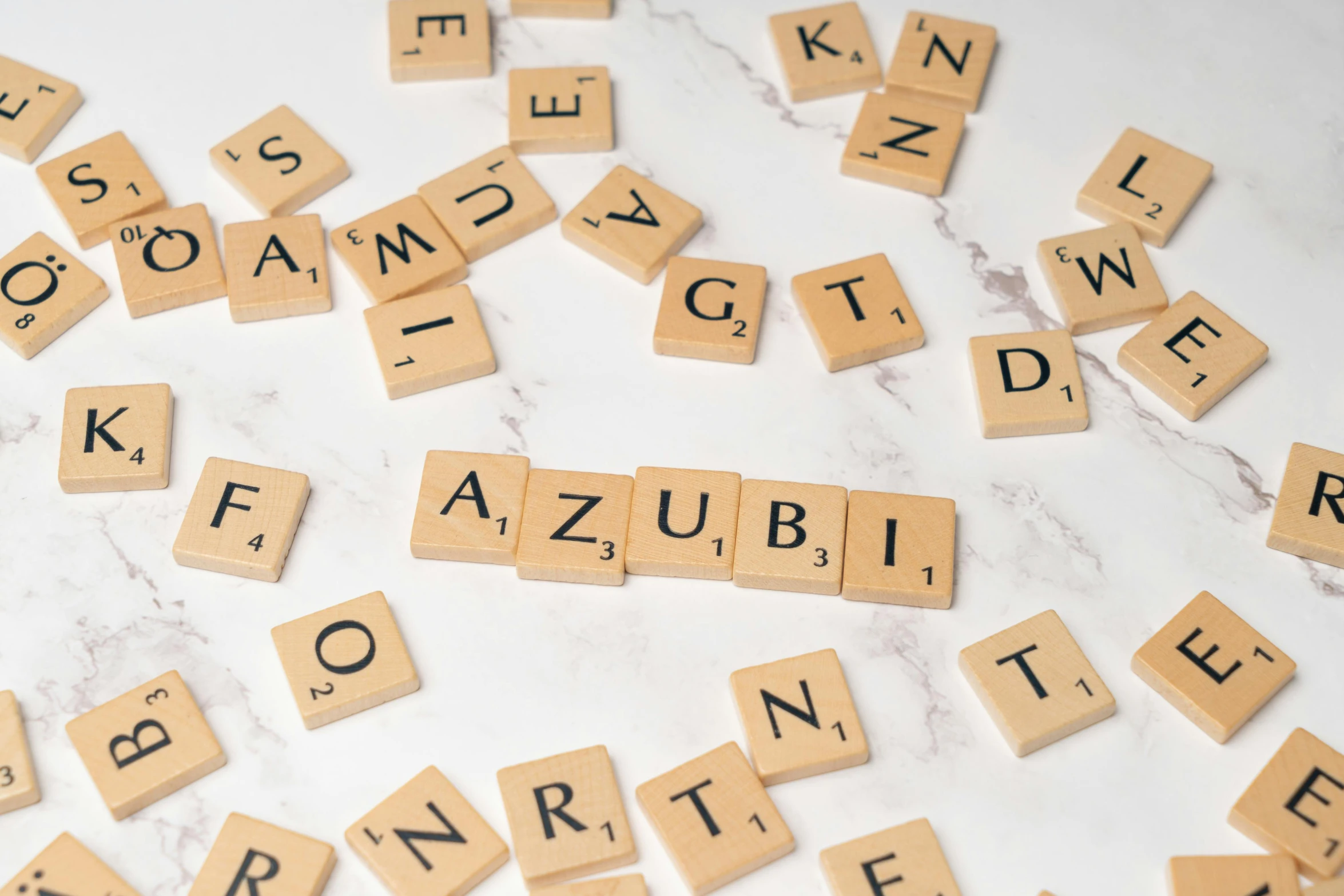 scrabbled letters that spell out a word as words from scrabbles and a keyboard are laid out on a table