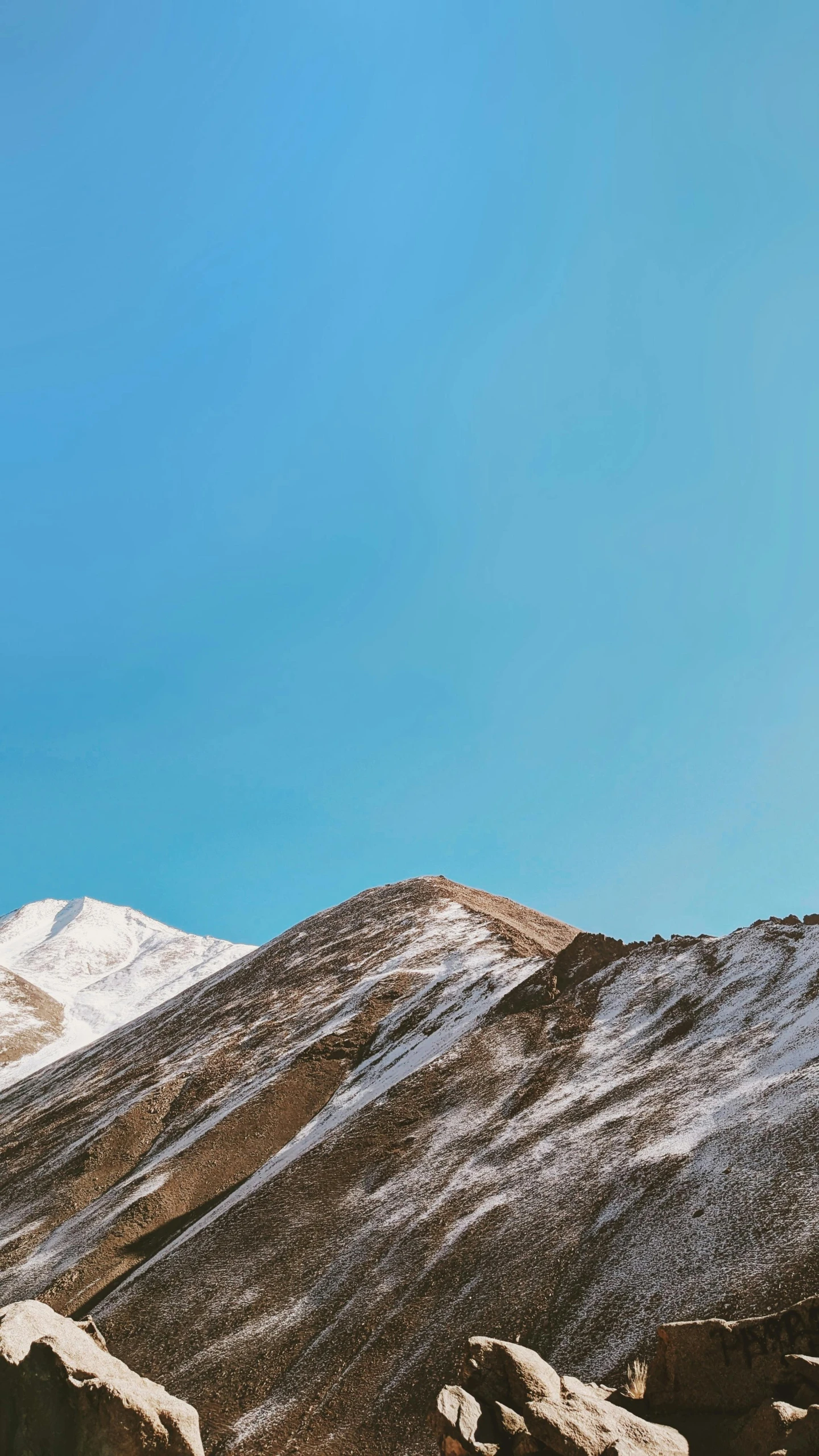 a lone man on the snow in the mountains