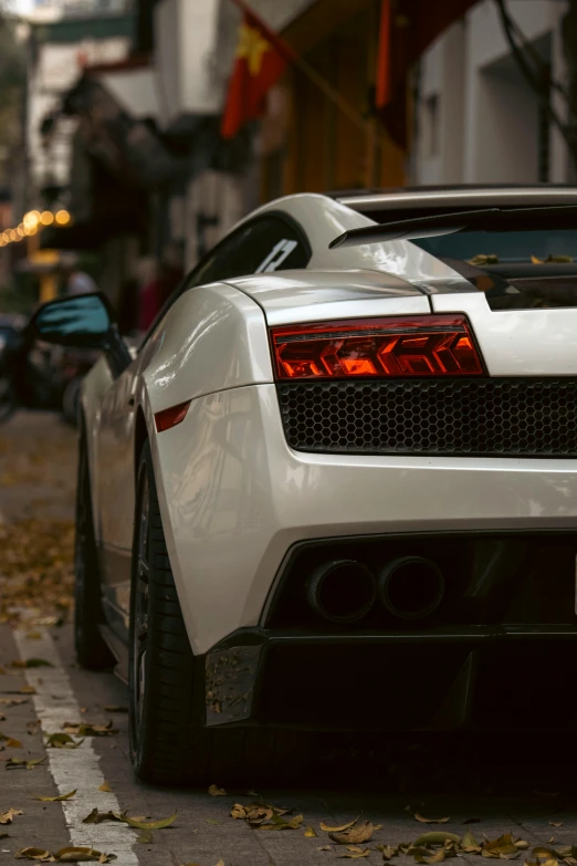 the back end of a white sports car