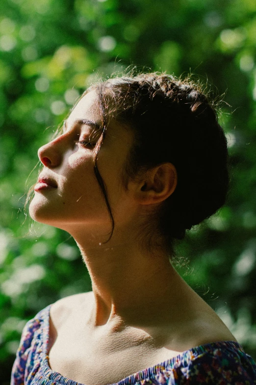 a woman looks up as she stands against the backdrop