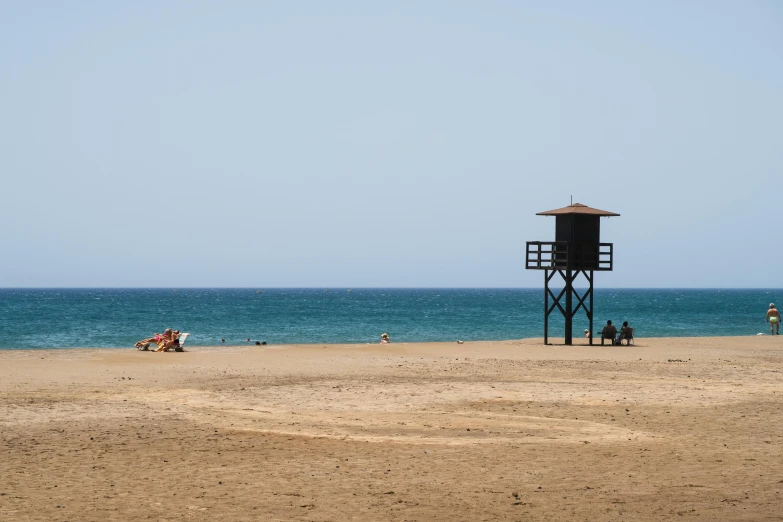 a life guard tower sitting on the beach near water