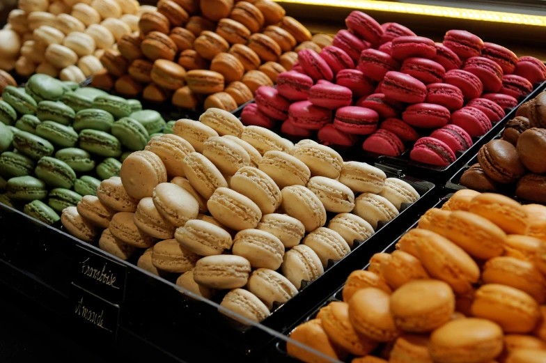 many different colored macaroons lined up in rows