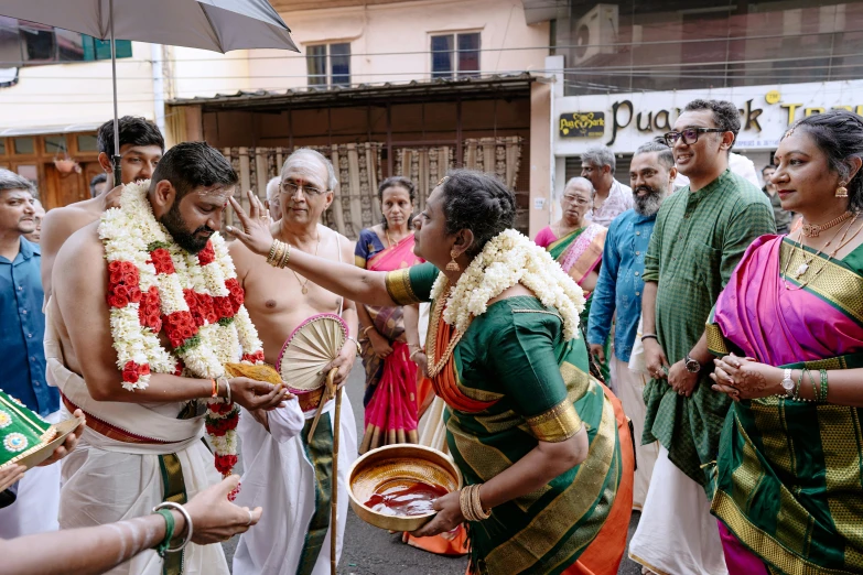 a man being handed a paper plate by women