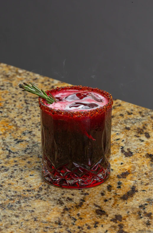 a small red drink sitting on a counter top