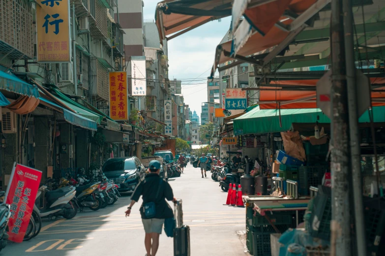 a woman is walking down an asian city