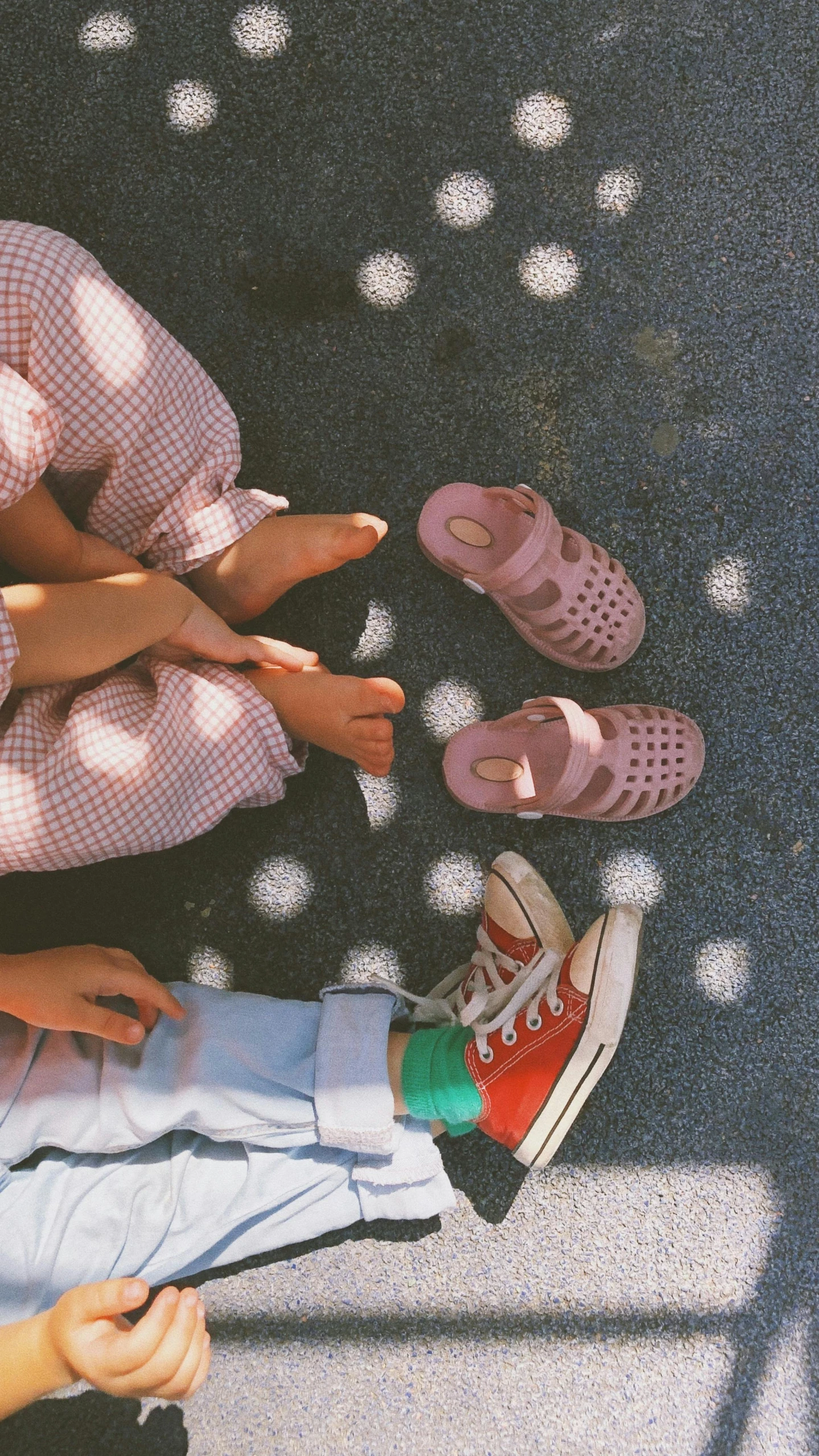 three people in pink shoes are standing together