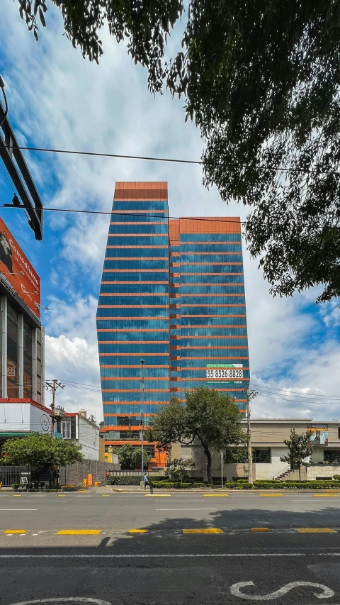 the buildings are very tall and there is a blue sky