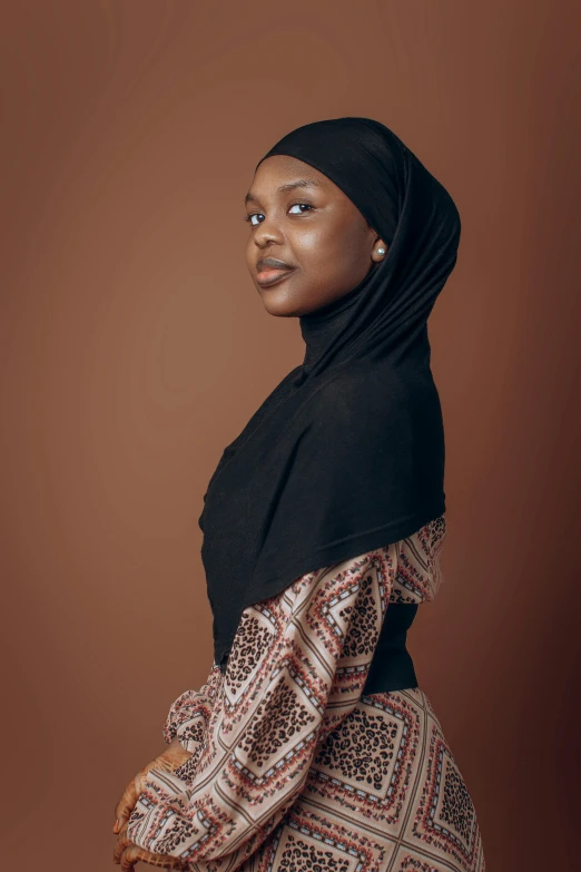 a woman in black and brown clothes standing