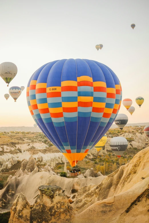 the  air balloons are taking off from a mountain