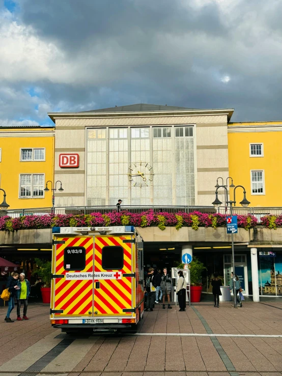 an emergency vehicle parked outside a large yellow building