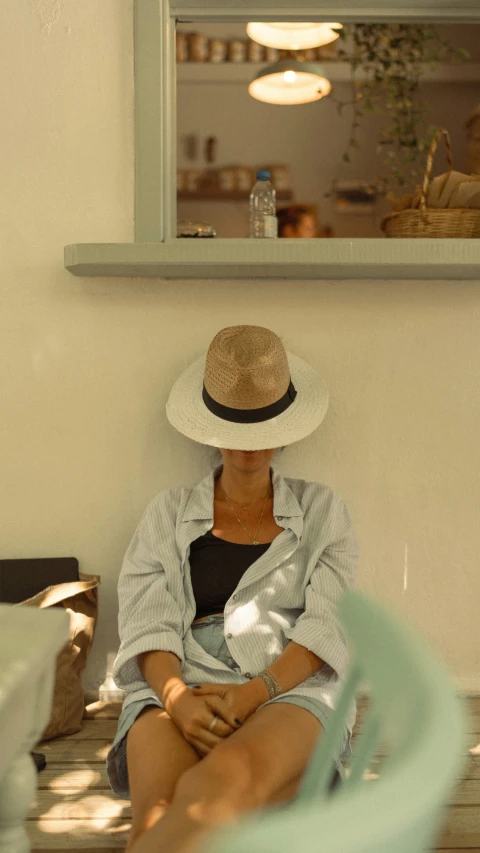 a woman sitting on top of a wooden floor