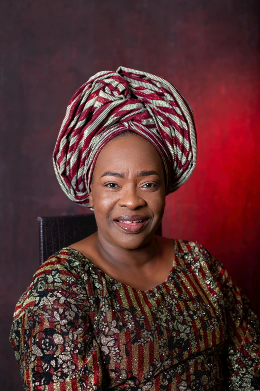 a woman in a patterned dress and a head piece