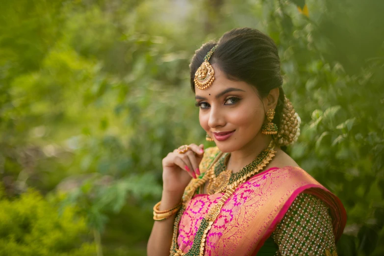a pretty woman in traditional indian dress posing for the camera