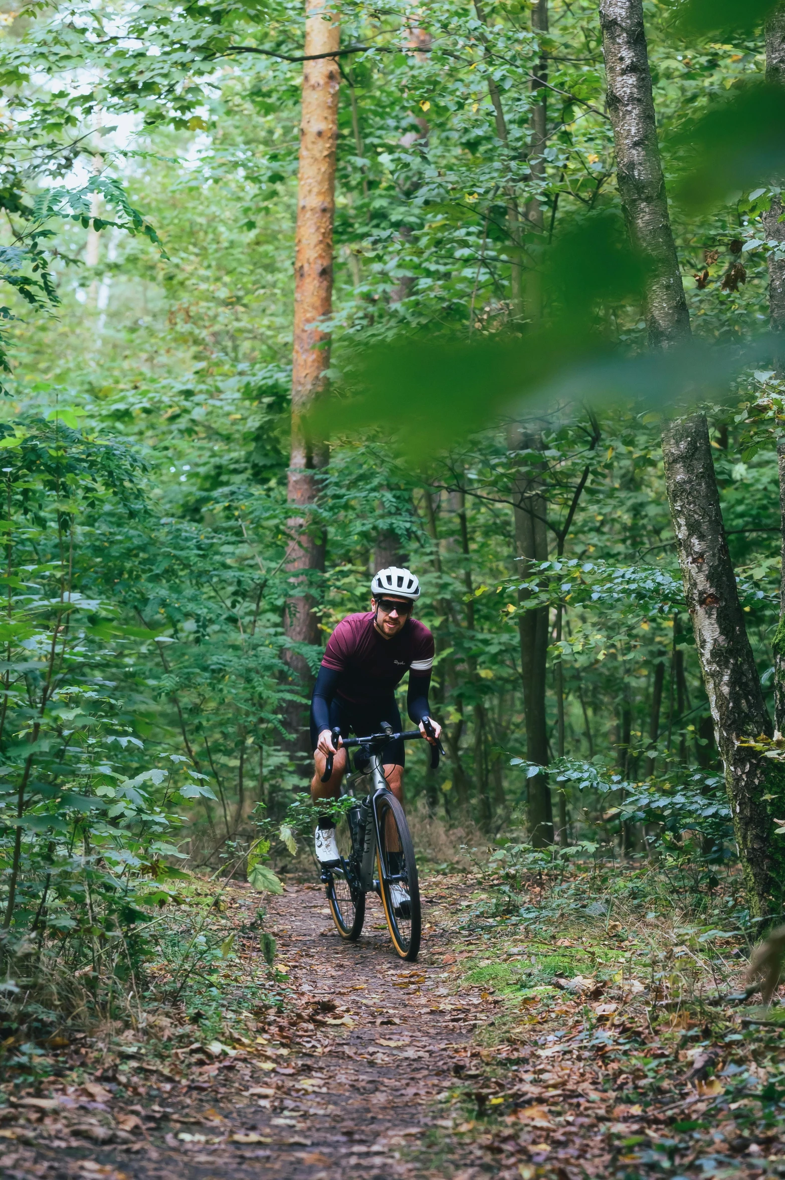 a man riding on a bike in the forest