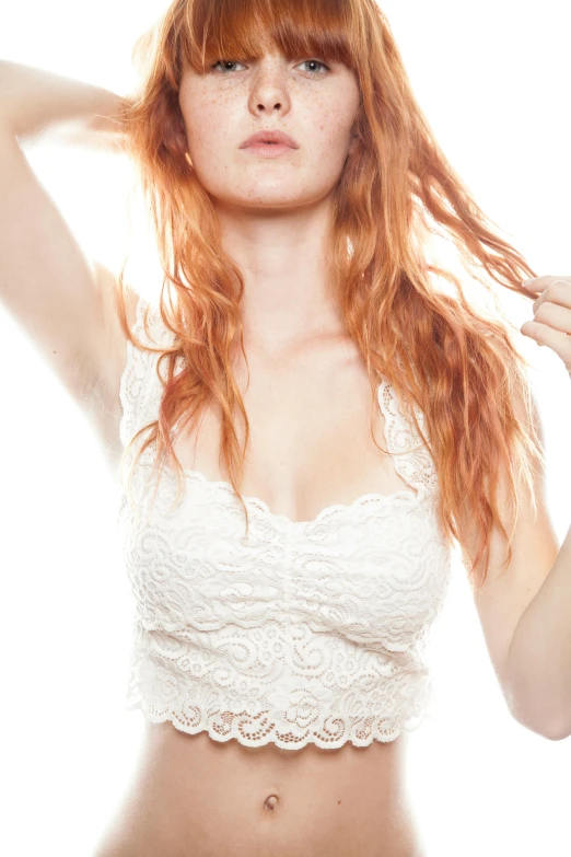 an orange haired woman in a white top is shown