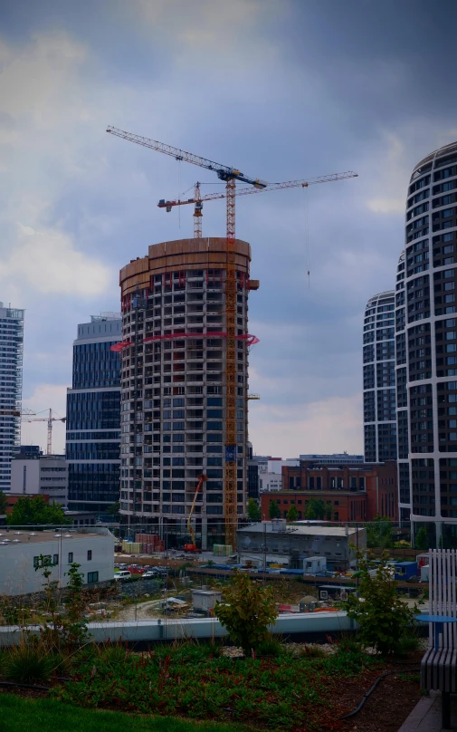 a picture of some buildings with cranes on top