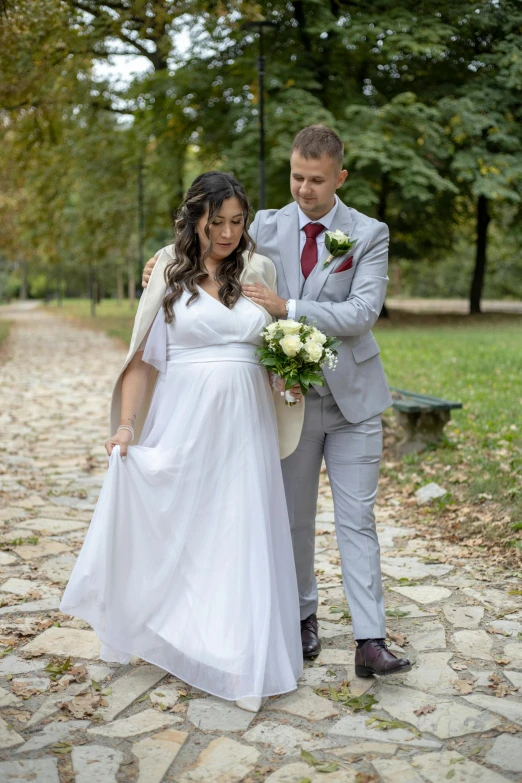 a man and woman standing on a path