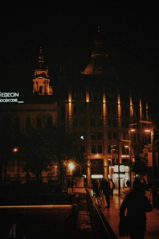 a couple of people walk past an old building