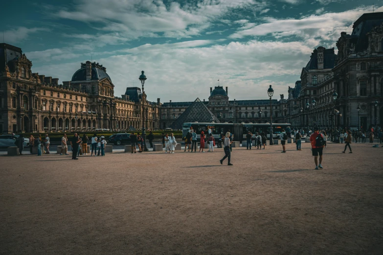 people walking around outside a castle like building