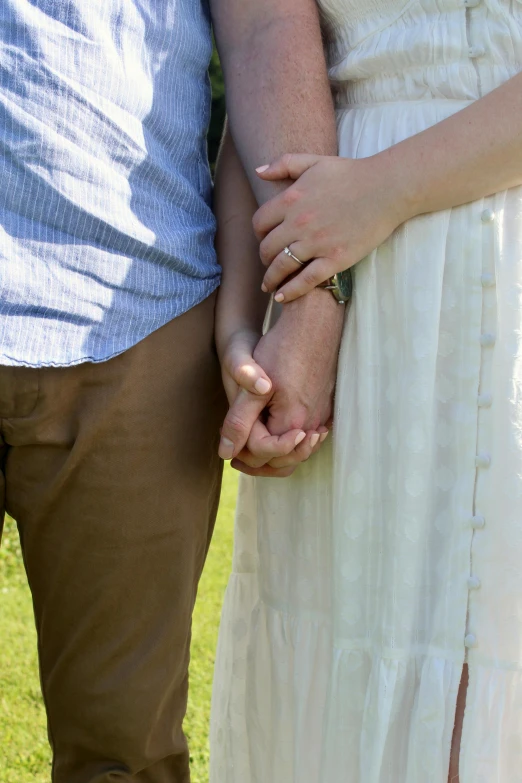 a woman holding the hand of a man