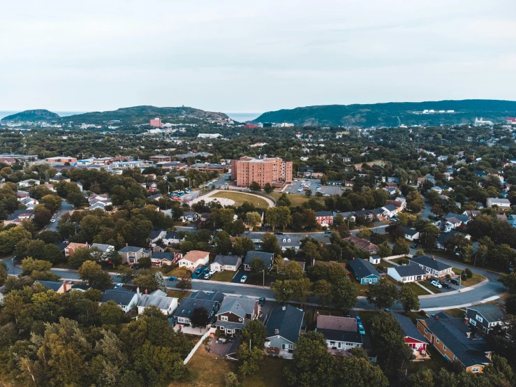 aerial view of suburbs in residential setting under blue sky