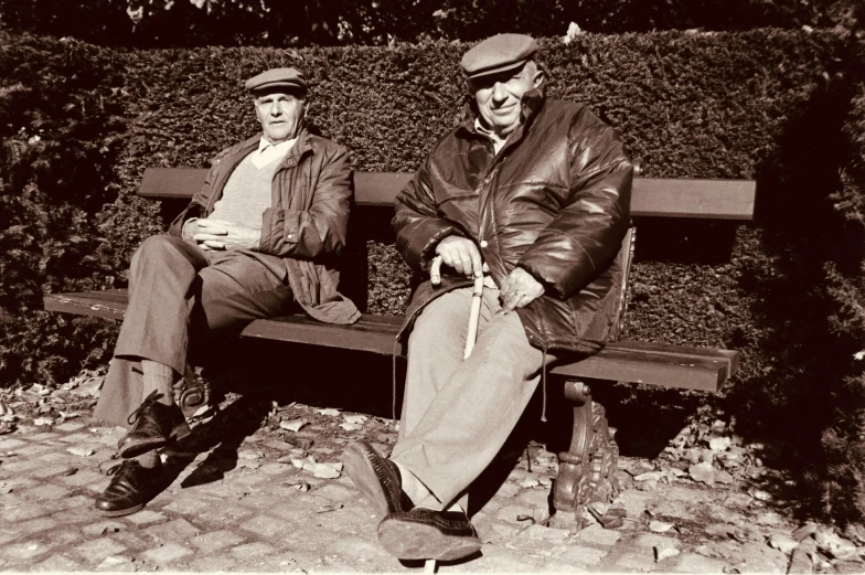 there are two older people sitting on a bench