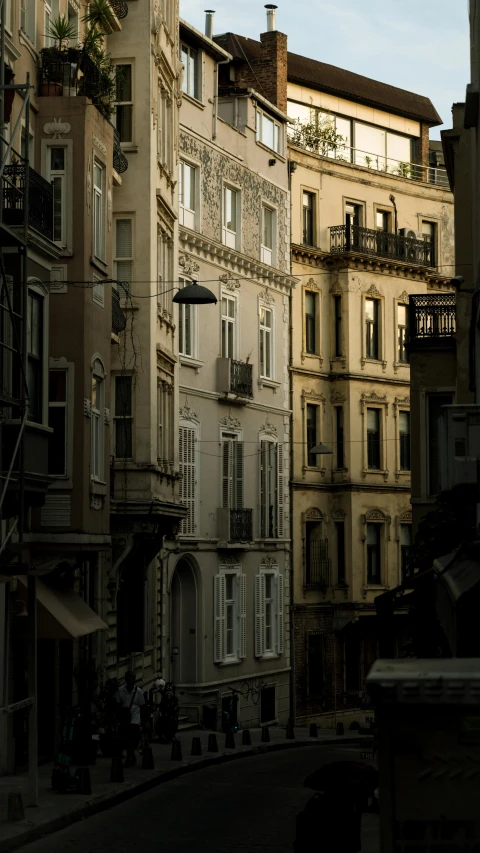 a street is crowded with apartment buildings and pedestrians